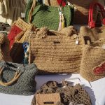 Photo du stand à une manifestation avec des sacs et pochettes crochetés